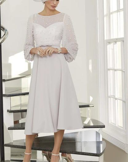 Pearl-embellished ball sleeves dress from EDKAY COLLECTION UK, elegant black clothing with stylish pearl accents and feminine design.
