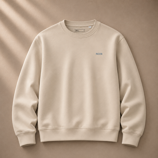 Dress 2 Impress Ltd D2I Noir Essential Sweatshirt in Desert Dust, showing a casual beige and black clothing item with a relaxed fit.