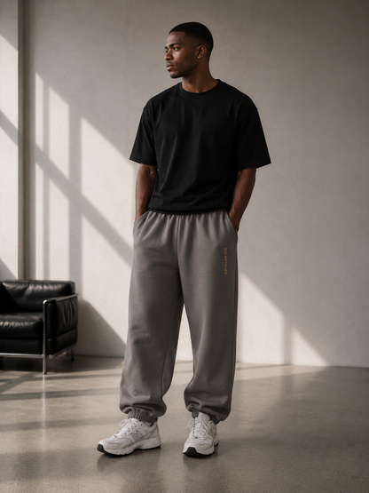 Dark grey D2I Artelier heavyweight fleece sweatpants for men, featuring a relaxed fit and comfortable elastic waistband.
