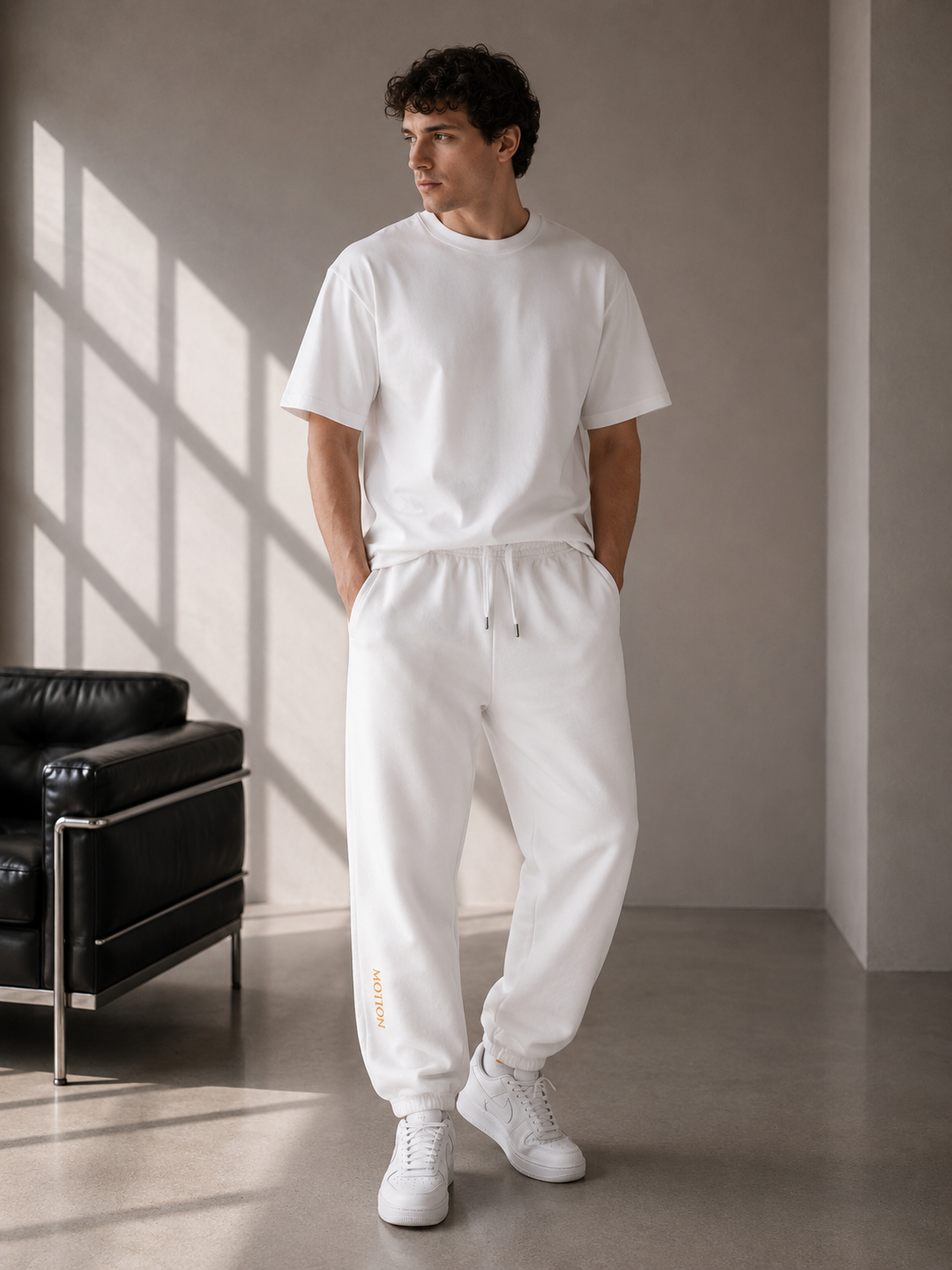 Model wearing D2I Motion heavy weight sweatpants by Dress 2 Impress Ltd, showcasing the comfortable, tapered fit and soft fabric.